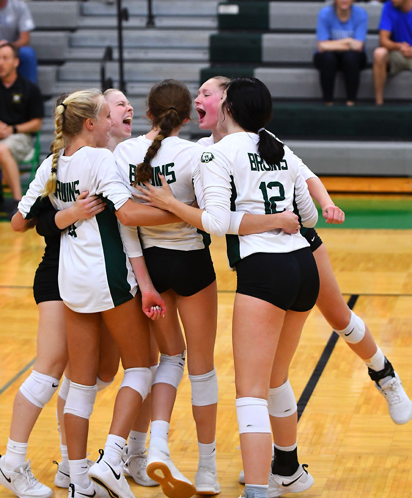 The Rock Bridge volleyball team celebrates after snagging a point against Hermann High School